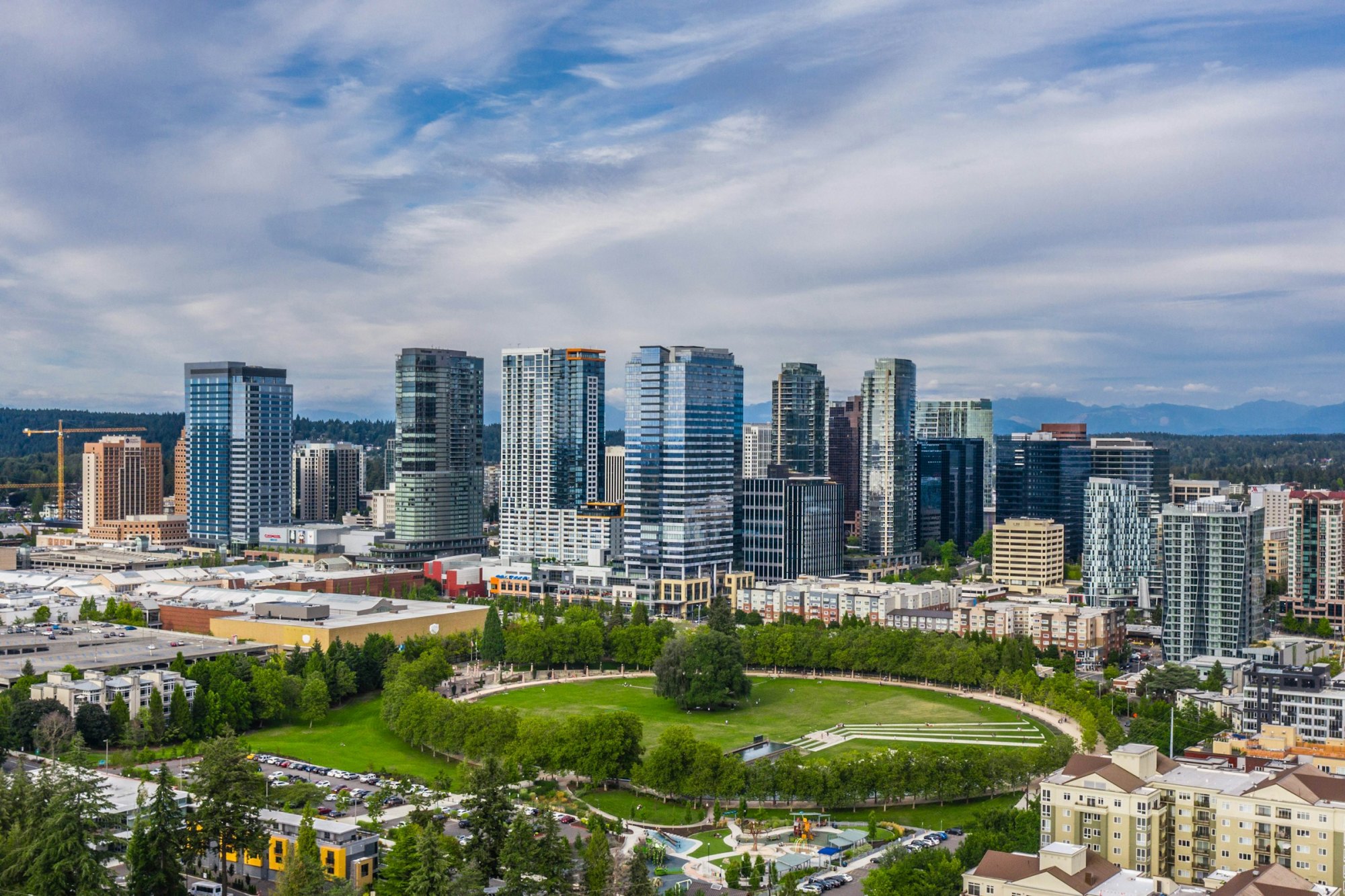 Aerial view of downtown Bellevue glass towers behind a circular green park