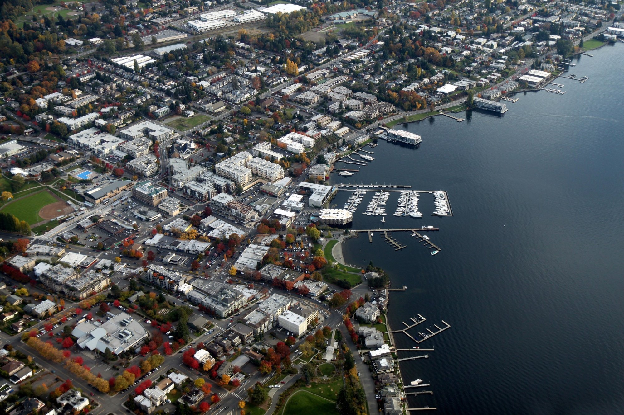 Aerial view of downtown Kirkland and its marina on Lake Washington in autumn colors