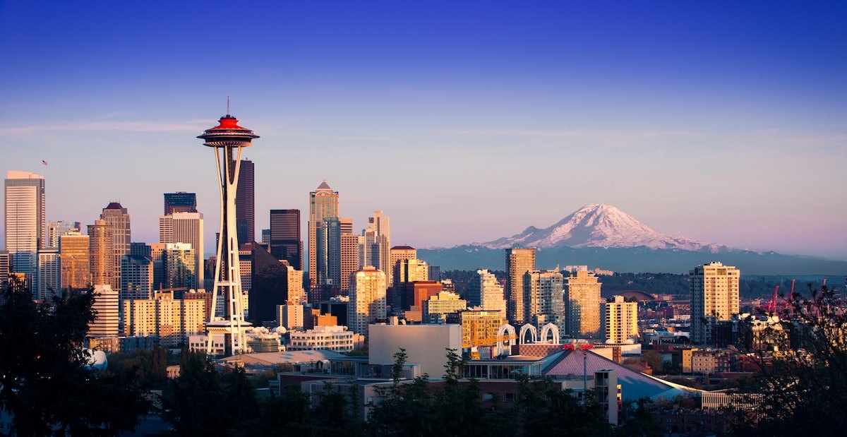 Seattle skyline with the Space Needle and Mount Rainier at dusk