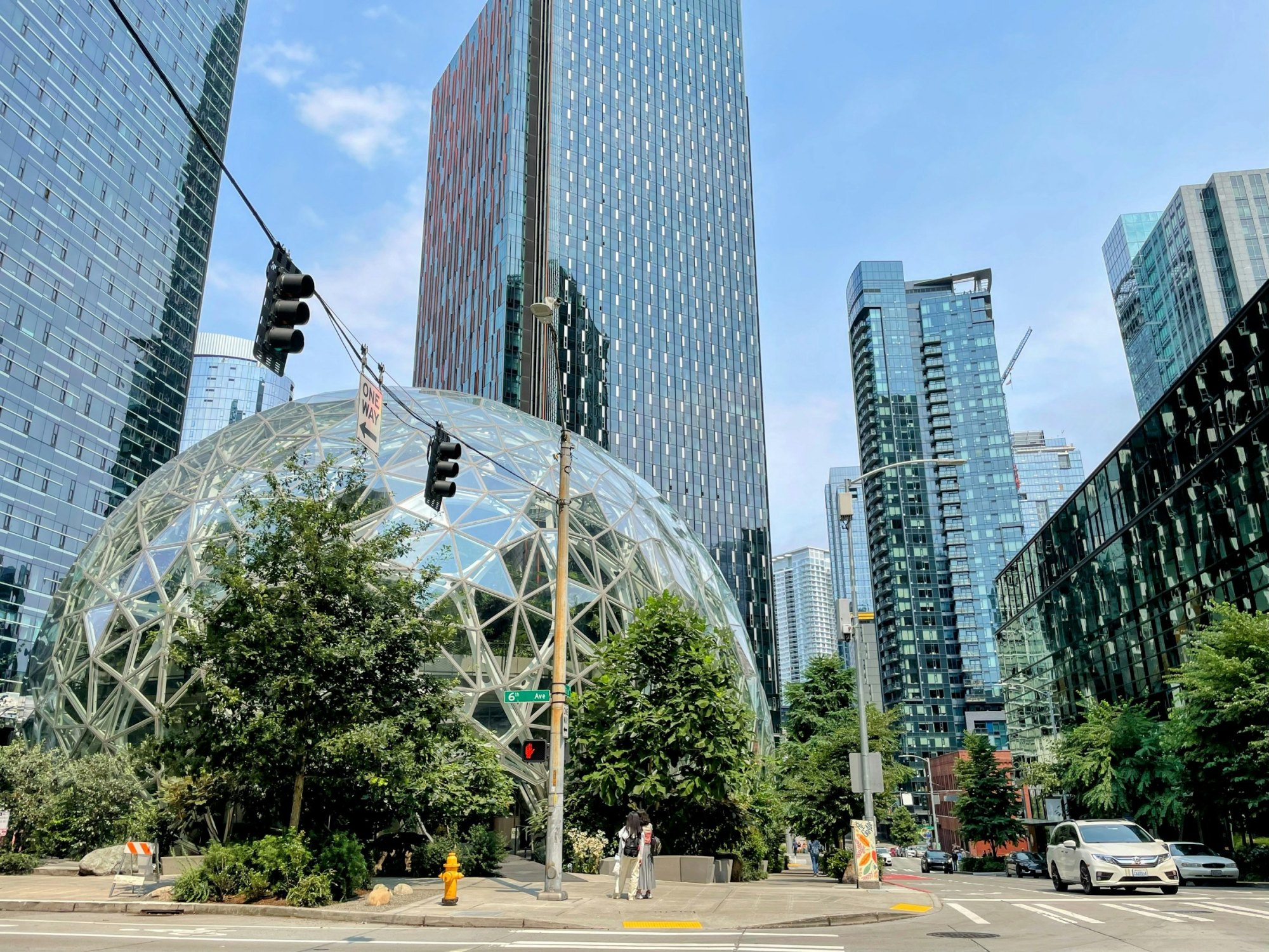 Sunny downtown Seattle street corner with glass sphere conservatory and high-rise towers